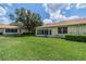 Back exterior of house showcasing a large yard and sunroom at 2346 Nantucket Dr # 58, Sun City Center, FL 33573