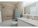 Updated bathroom with tub, shower, and white vanity at 2346 Nantucket Dr # 58, Sun City Center, FL 33573