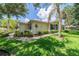 Single-story villa with a yellow exterior, blue shutters, and a well-maintained lawn at 2346 Nantucket Dr # 58, Sun City Center, FL 33573