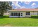 Back exterior view of house showing sunroom and landscaping at 2346 Nantucket Dr # 58, Sun City Center, FL 33573