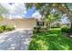 Single-story villa with a two-car garage and a lush green lawn at 2346 Nantucket Dr # 58, Sun City Center, FL 33573