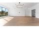Spacious living room with hardwood floors, white walls, and a sleek modern chandelier at 5006 W San Miguel St, Tampa, FL 33629