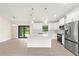 Open concept kitchen with white cabinets and large island at 9171 Prospect Ave, Englewood, FL 34224