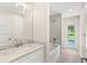 Bathroom with single vanity, bathtub, and exterior access at 9171 Prospect Ave, Englewood, FL 34224