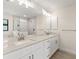 Modern bathroom with double vanity and marble countertops at 9171 Prospect Ave, Englewood, FL 34224