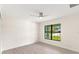 Spacious bedroom featuring a large window and ceiling fan at 9171 Prospect Ave, Englewood, FL 34224