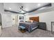 Spacious bedroom with a gray comforter and wood headboard at 7135 Graybrook Dr, Wesley Chapel, FL 33545