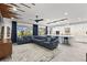 Spacious living room with sectional sofa, large TV, and open kitchen concept at 7135 Graybrook Dr, Wesley Chapel, FL 33545