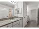 Bathroom with granite countertop, double sinks, and modern vanity at 7135 Graybrook Dr, Wesley Chapel, FL 33545