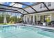 Screened pool and spa with a large patio and plenty of room for relaxation at 7135 Graybrook Dr, Wesley Chapel, FL 33545
