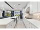 Bright kitchen features white cabinets, an island, and a view of the backyard at 7135 Graybrook Dr, Wesley Chapel, FL 33545
