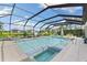 Enclosed pool and spa with a screened-in patio overlooking a lake at 7135 Graybrook Dr, Wesley Chapel, FL 33545