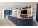 Open concept living room with sectional sofa and wood accent wall at 7135 Graybrook Dr, Wesley Chapel, FL 33545