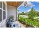 Relaxing front porch with seating area, lush landscaping, and neighborhood view at 7135 Graybrook Dr, Wesley Chapel, FL 33545