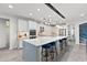 Modern kitchen with white cabinets, large island, and stainless steel appliances at 7135 Graybrook Dr, Wesley Chapel, FL 33545