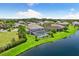 Lakefront property with a large house and pool in a luxury community at 7135 Graybrook Dr, Wesley Chapel, FL 33545