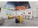 Fun game room with colorful ceiling and comfortable seating at 7135 Graybrook Dr, Wesley Chapel, FL 33545