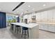 Spacious kitchen boasts a large island, white cabinetry, and stylish backsplash at 7135 Graybrook Dr, Wesley Chapel, FL 33545