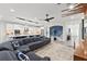 Spacious living area with sectional sofa, open kitchen, and modern design at 7135 Graybrook Dr, Wesley Chapel, FL 33545