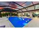Night view of a screened-in pool and spa, offering tranquil ambiance at 7135 Graybrook Dr, Wesley Chapel, FL 33545