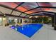 Relaxing blue swimming pool with a sun shelf and LED lights at 7135 Graybrook Dr, Wesley Chapel, FL 33545