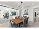 Bright dining room with wood table, gray chairs, and open concept design at 7135 Graybrook Dr, Wesley Chapel, FL 33545