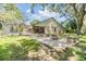 Beautiful backyard featuring a fire pit with seating and a screened-in pool at 3501 Country Creek Ln, Valrico, FL 33596