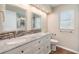 Bathroom featuring granite counters, double sinks, decorative tile backsplash, wood look flooring, and a window at 3501 Country Creek Ln, Valrico, FL 33596