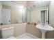 Small bathroom with pedestal sink, large mirror, and toilet at 3501 Country Creek Ln, Valrico, FL 33596