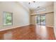 Bedroom with hardwood floors and sliding glass door to outdoor pool and screened-in patio at 3501 Country Creek Ln, Valrico, FL 33596