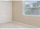 Bedroom with wood floors, a window with blinds, and a closet with sliding doors at 3501 Country Creek Ln, Valrico, FL 33596