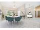 The dining area features a modern chandelier, a light-filled window, and updated tile floors at 3501 Country Creek Ln, Valrico, FL 33596