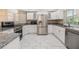 Modern kitchen featuring white cabinets, granite counters, and stainless steel appliances at 3501 Country Creek Ln, Valrico, FL 33596