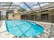 Inviting pool area with a full screen enclosure and well-maintained landscaping at 3501 Country Creek Ln, Valrico, FL 33596