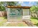 Exterior shot of shed with open beams and a large painted map on the outside at 3501 Country Creek Ln, Valrico, FL 33596