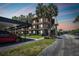 Apartment building exterior with covered parking and landscaping; showing building access at 8693 Bardmoor Blvd # 308B, Seminole, FL 33777