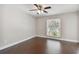 Bedroom with ceiling fan, window, and wood floors at 8693 Bardmoor Blvd # 308B, Seminole, FL 33777