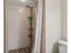 Shower stall with pebble stone floor and shower caddy at 8693 Bardmoor Blvd # 308B, Seminole, FL 33777
