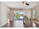 Living room with hardwood floors, balcony access and a ceiling fan at 8693 Bardmoor Blvd # 308B, Seminole, FL 33777