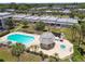 Community pool and hot tub with surrounding lounge chairs at 8693 Bardmoor Blvd # 308B, Seminole, FL 33777