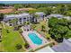 Community pool and spa with surrounding patio and lawn at 8693 Bardmoor Blvd # 308B, Seminole, FL 33777