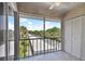Screened balcony overlooks lush landscaping and parking area at 8693 Bardmoor Blvd # 308B, Seminole, FL 33777