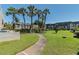 Landscaped courtyard with palm trees and a walking path, offering a tranquil outdoor space at 8693 Bardmoor Blvd # 308B, Seminole, FL 33777