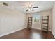Bright bedroom featuring dark wood floors and two bookshelves at 8693 Bardmoor Blvd # 308B, Seminole, FL 33777