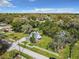 Aerial view of a charming two-story home with a spacious yard and serene surroundings under a blue sky at 510 Tighe Ave, Seffner, FL 33584