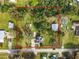 Aerial view of the property surrounded by lush greenery showcasing the expansive lot outlined in red at 510 Tighe Ave, Seffner, FL 33584