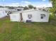 Single-wide mobile home with long covered carport at 5353 Comanche St, Zephyrhills, FL 33542