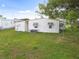 Single-wide mobile home with long covered carport at 5353 Comanche St, Zephyrhills, FL 33542