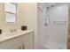 Bathroom with white vanity and a walk-in shower at 5353 Comanche St, Zephyrhills, FL 33542