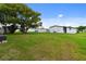 Mobile home with a large, grassy backyard at 5353 Comanche St, Zephyrhills, FL 33542